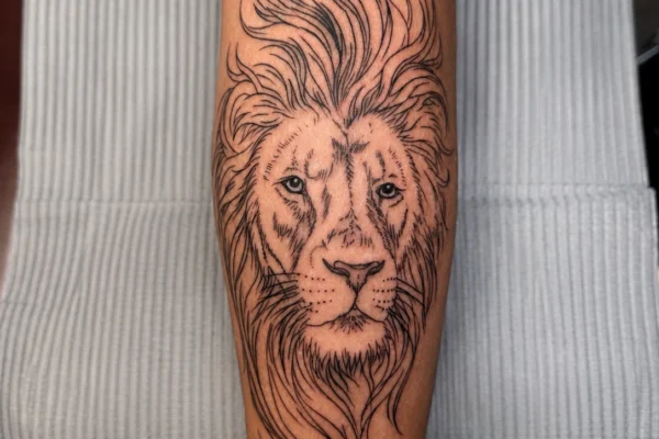 lion-head-black-ink-leg-tattoo-wicked-tattoos